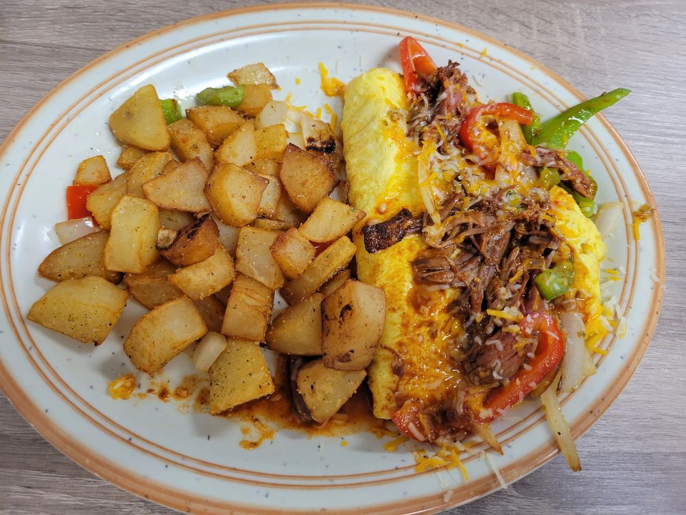 Omelette filled with slow-braised birria, peppers and melted cheese, served with seasoned potatoes